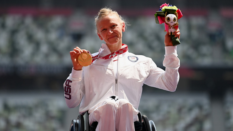 Susannah Scaroni holding gold medal and Tokyo medallion 