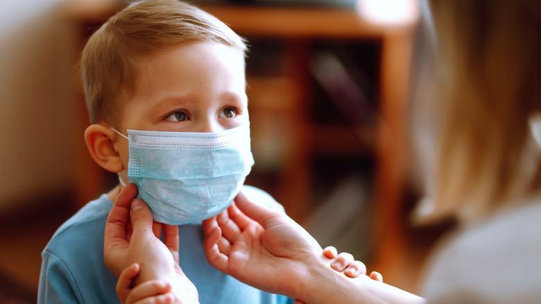 Little boy and mom in medical mask