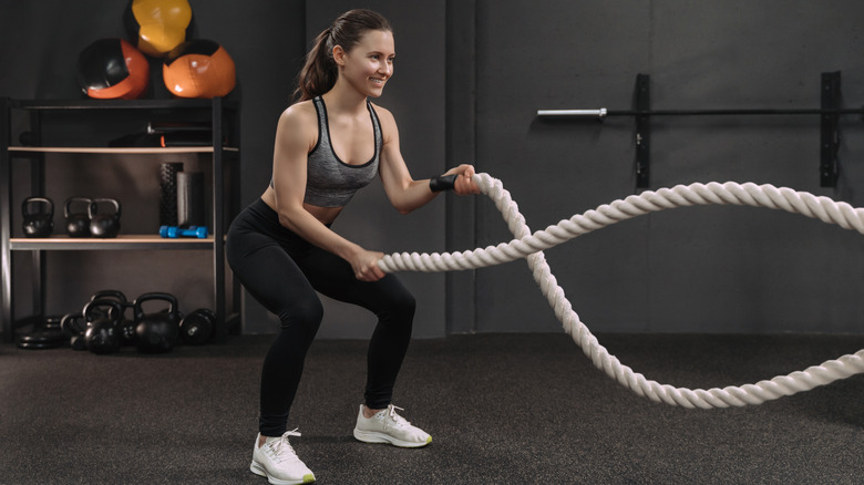 Woman working out with ropes