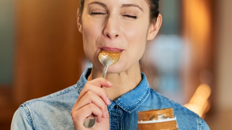 Woman eating peanut butter