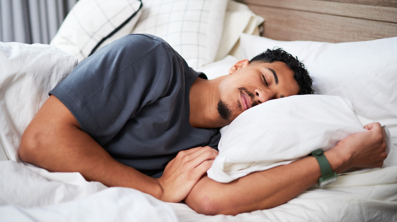 man sleeping in bed