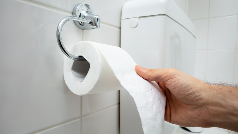 Man reaching for toilet paper