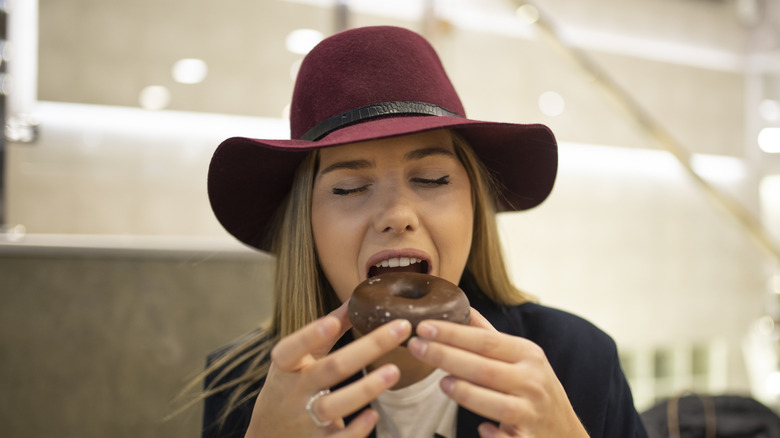 woman enjoying a donut