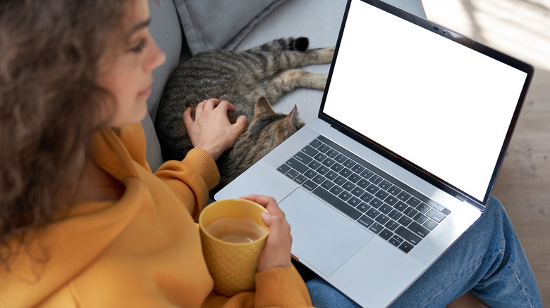 Woman on computer enjoying coffee