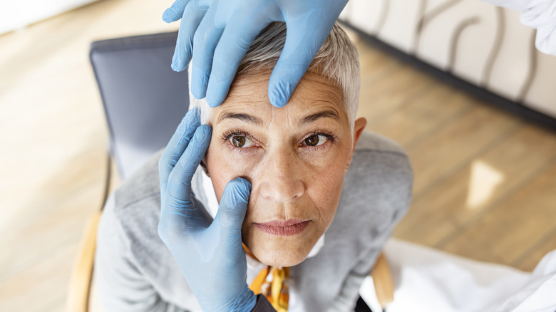 Eye doctor examining woman's eye