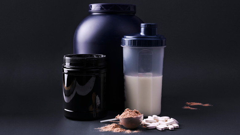 Various sports powders and supplements on black background