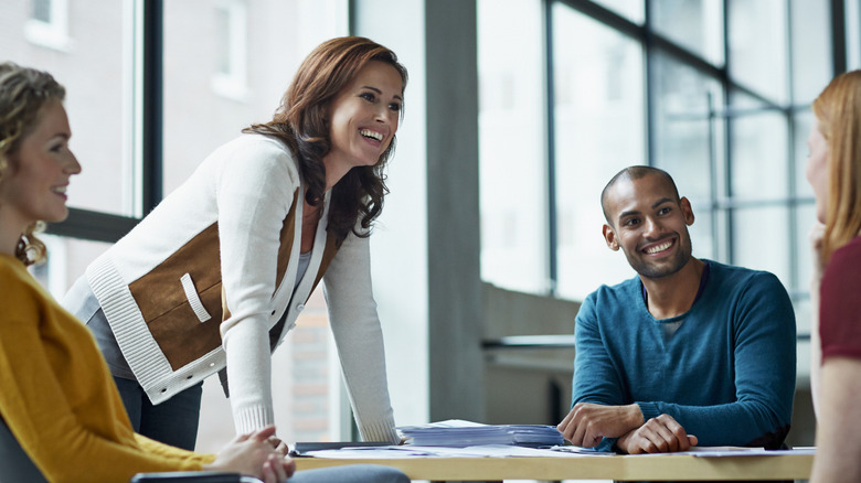 group of coworkers smiling and discussing