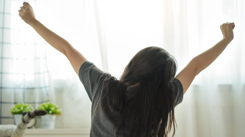 a woman waking up and feeling good