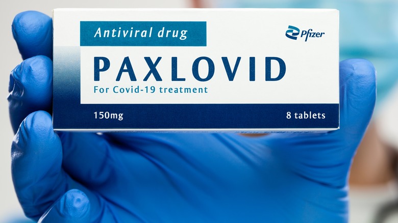 A box of Paxlovid in gloved hand