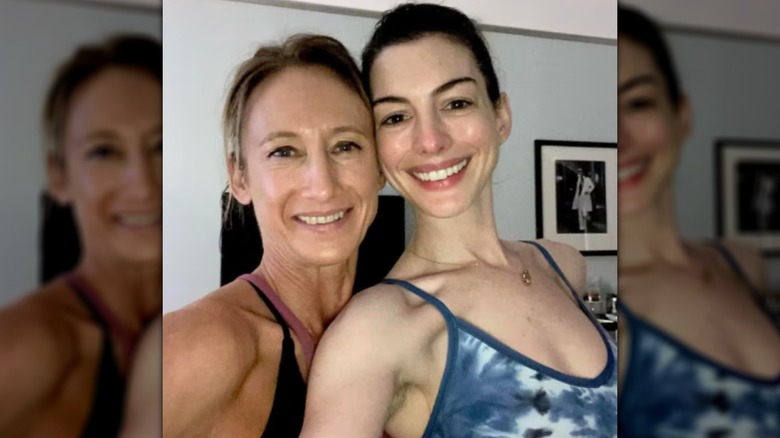 Anne Hathaway with her personal trainer
