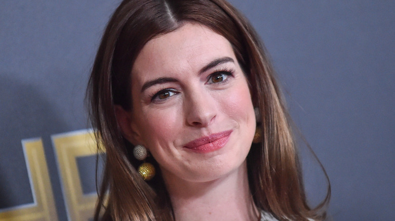 Anne Hathaway shows off her glowing skin during a 2018 publicity event