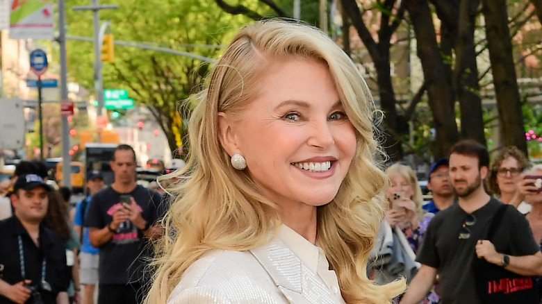 Christie Brinkley posing at an event held outside