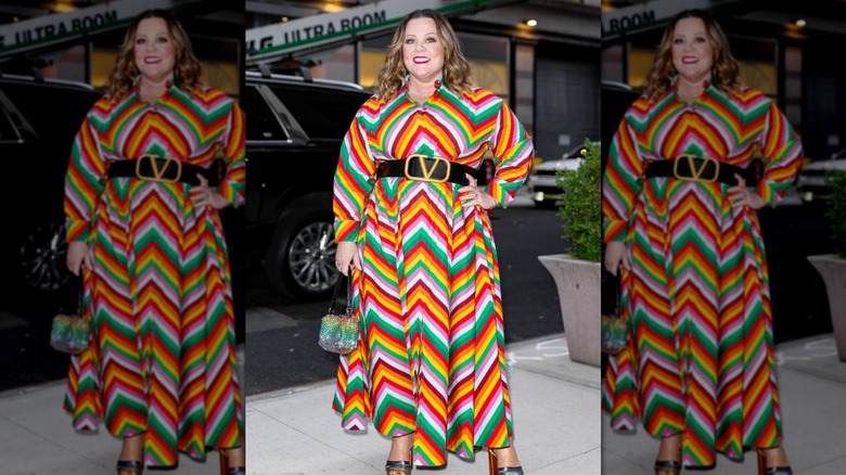 Melissa McCarthy smiling in a multicolored dress