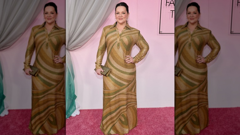 Melissa McCarthy posing in a brown outfit