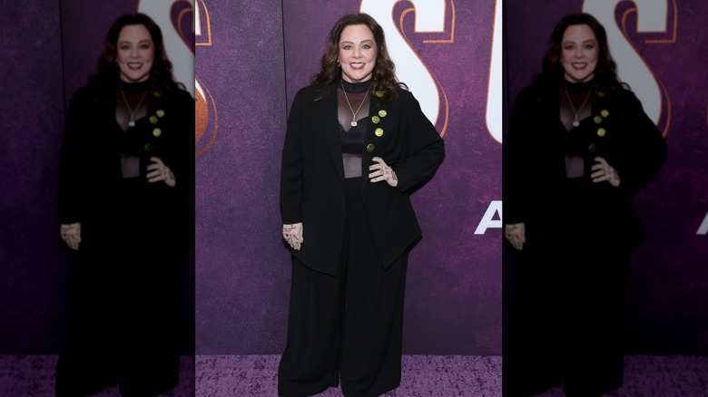 Melissa McCarthy smiling in an all-black outfit