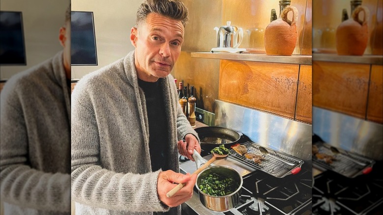 Ryan Seacrest posing for a photo with green vegetables