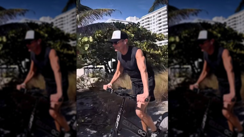 Ryan Seacrest riding a bicycle without a seat