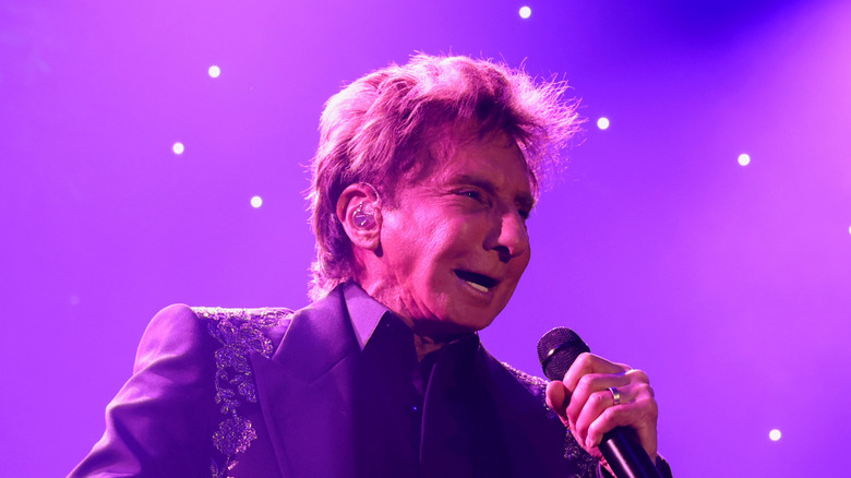 Barry Manilow performs on stage in 2025