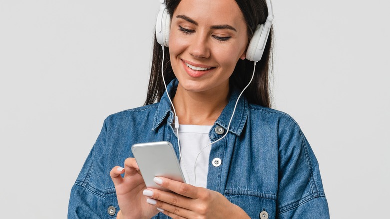 girl with headphones listening to podcast