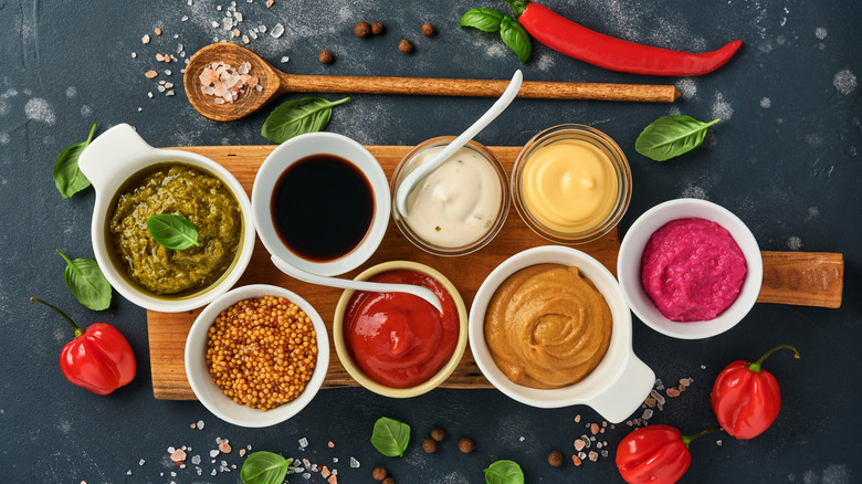 Different condiments in glass bowls