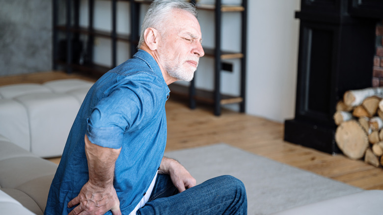 Older man experiencing lower back pain