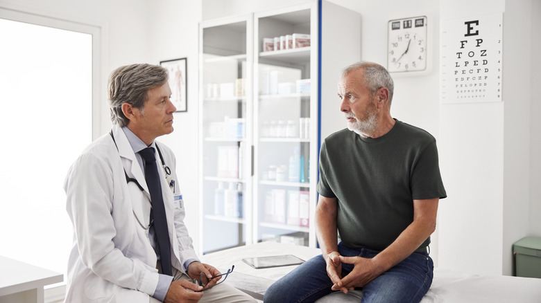 older man talking with doctor