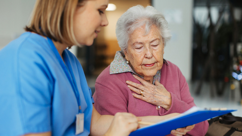 nurse showing chart to older woman