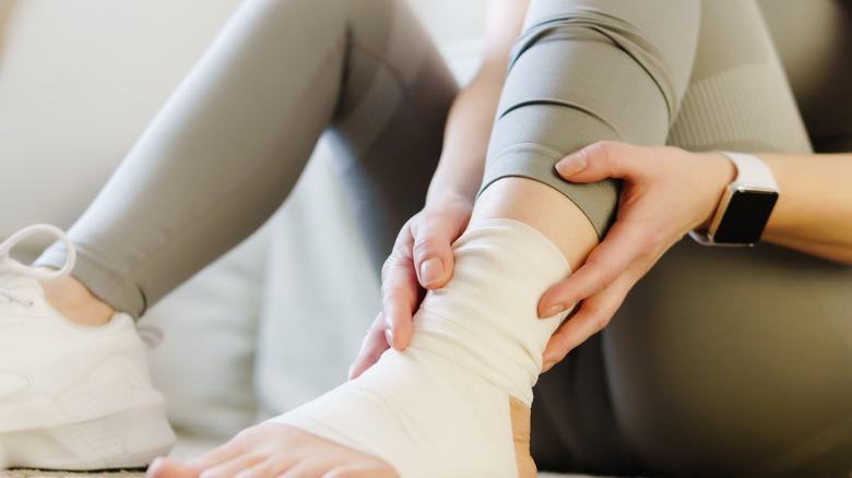 woman with ankle wrapped in bandages