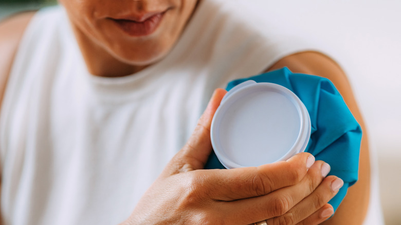 man holding ice pack on arm