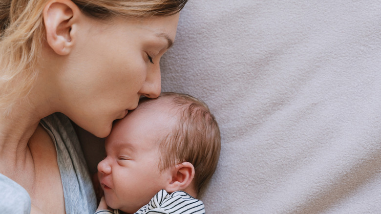 Mother kissing her infant