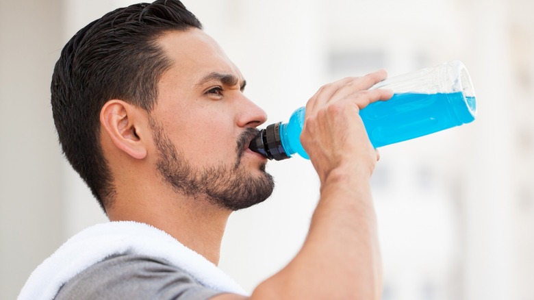 man drinking sports drink