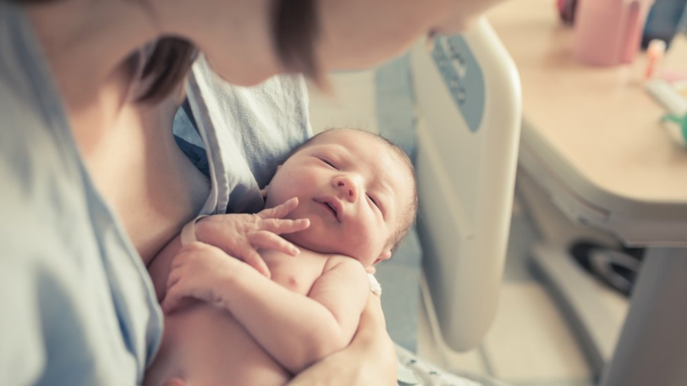 Mom holds newborn baby