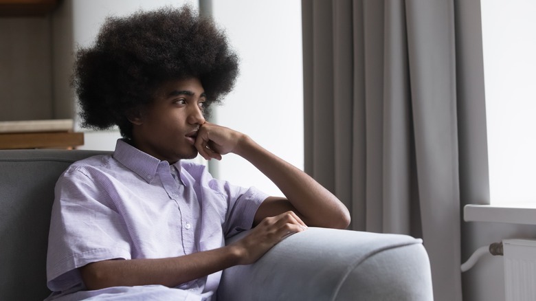 Person sitting and looking out window