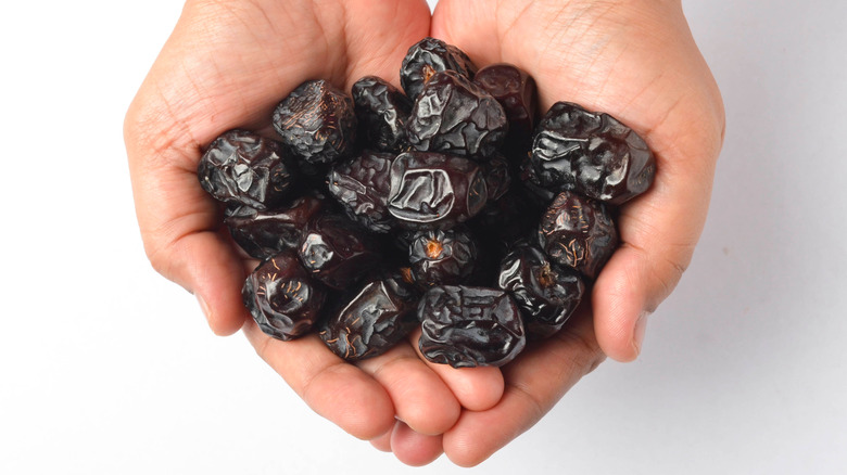 open handfuls of dried dates