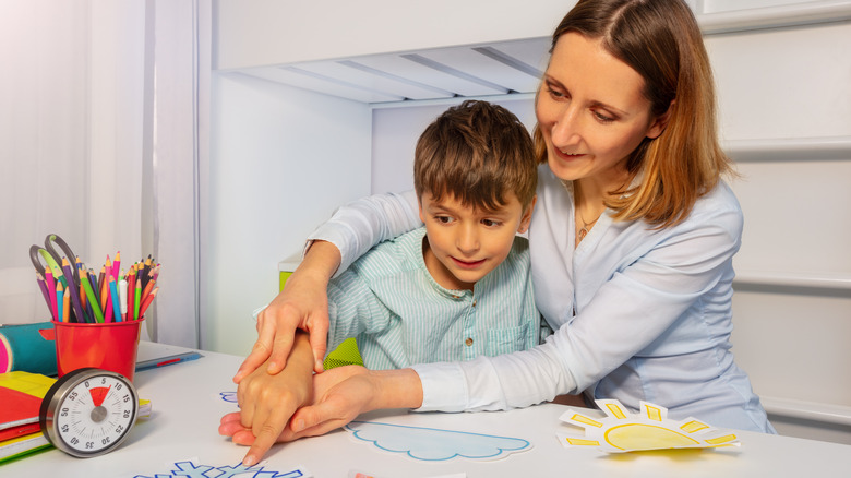 woman with child pointing to a shape