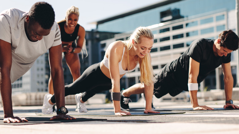 People doing pushups outdoors