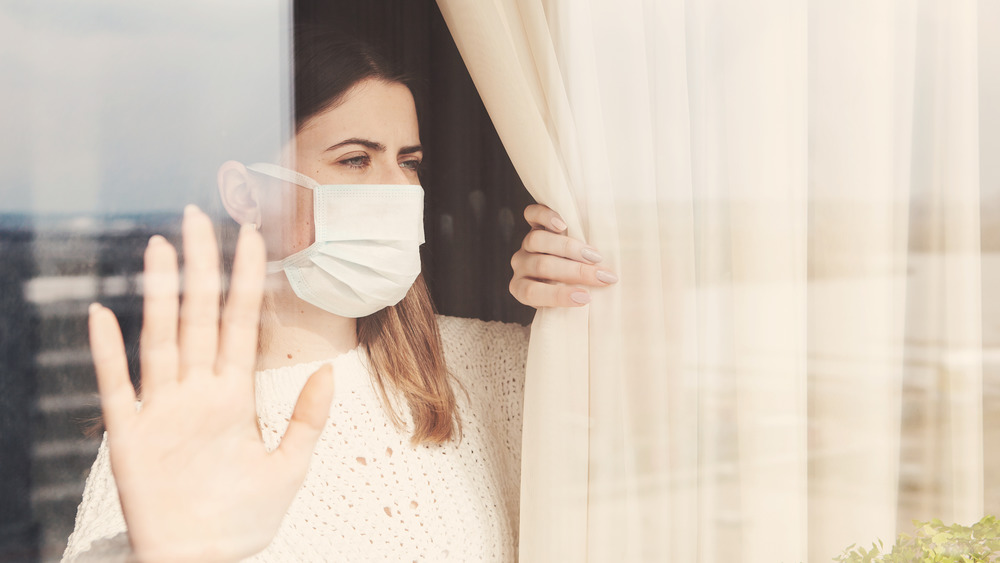 Woman in isolation at window