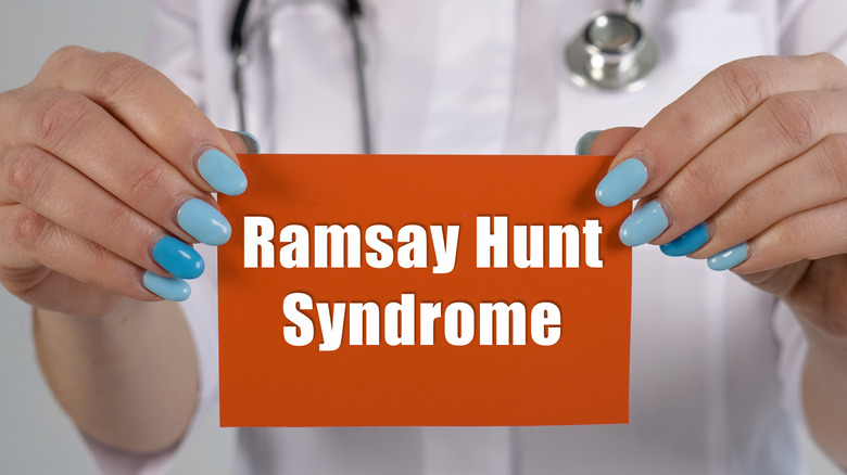 Person holding sign that says Ramsay Hunt Syndrome