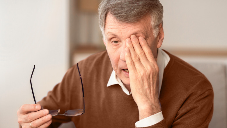 Elderly man having trouble seeing