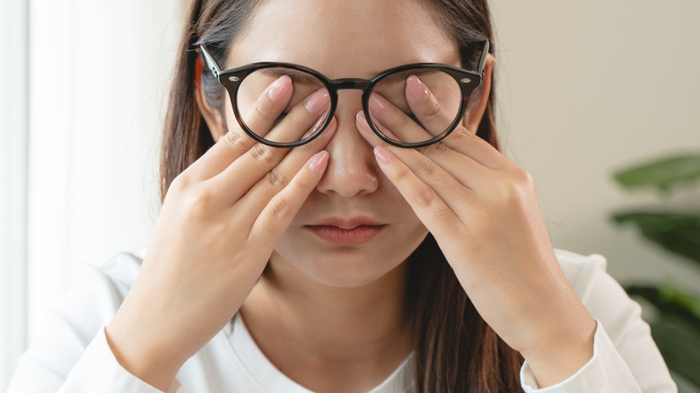 Woman rubbing tired eyes