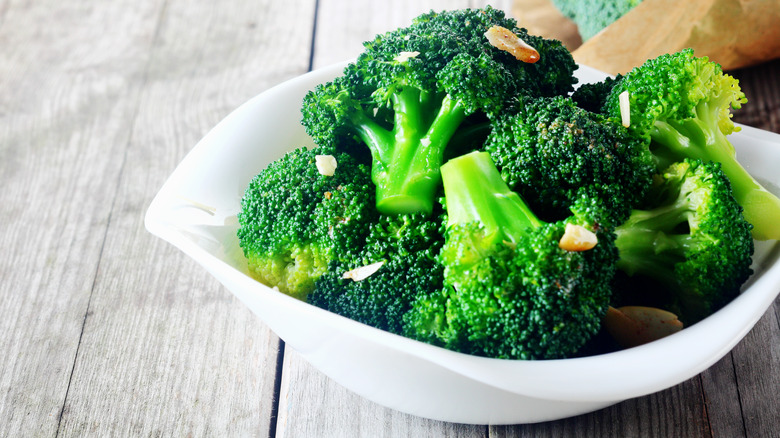 close up of cooked broccoli in a dish