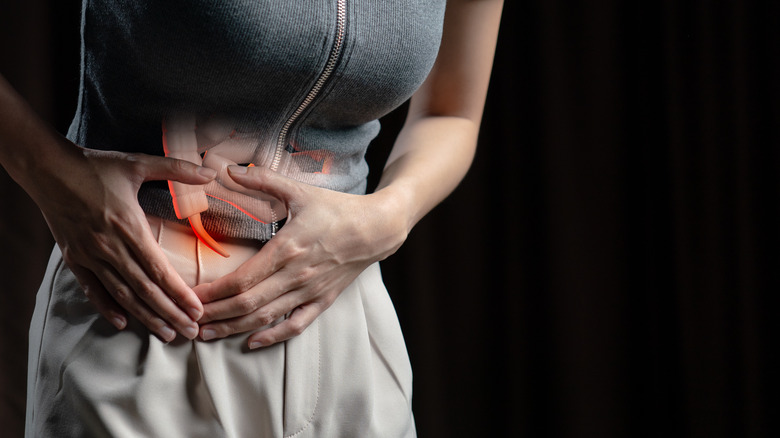 Woman holding her stomach in pain