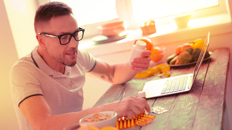Man taking nootropics while working on the computer