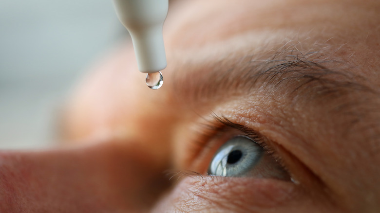 Person using eye drops