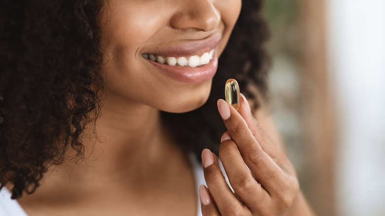 Woman taking an omega-3 supplement