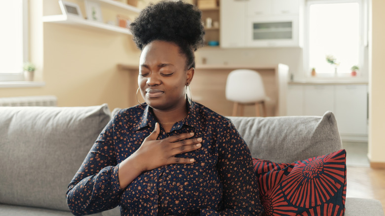 Woman holding chest