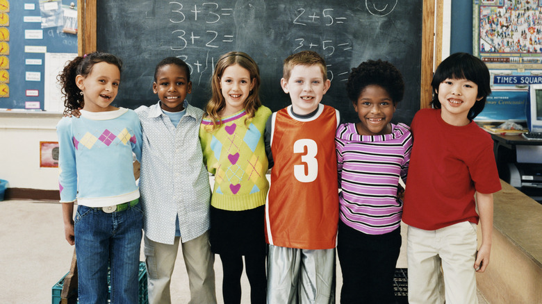 several children at a chalkboard at school