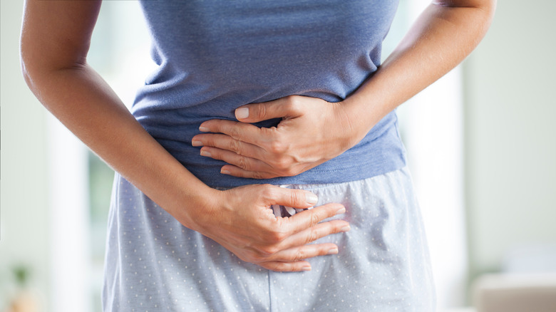 Woman holding abdomen