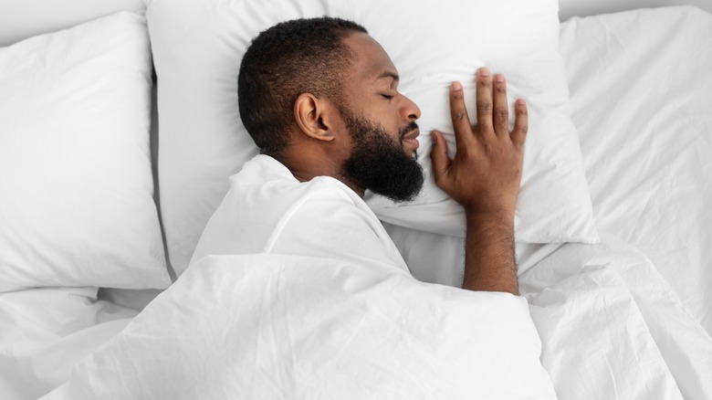 Man asleep in bed