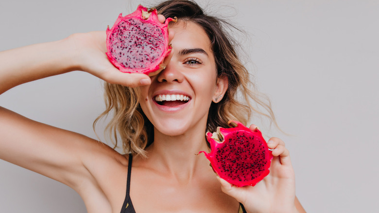 Woman holding dragon fruit